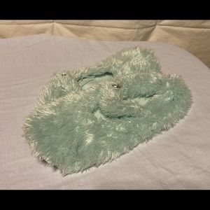 Fuzzy slippers with sparkling rhinestone buttons.